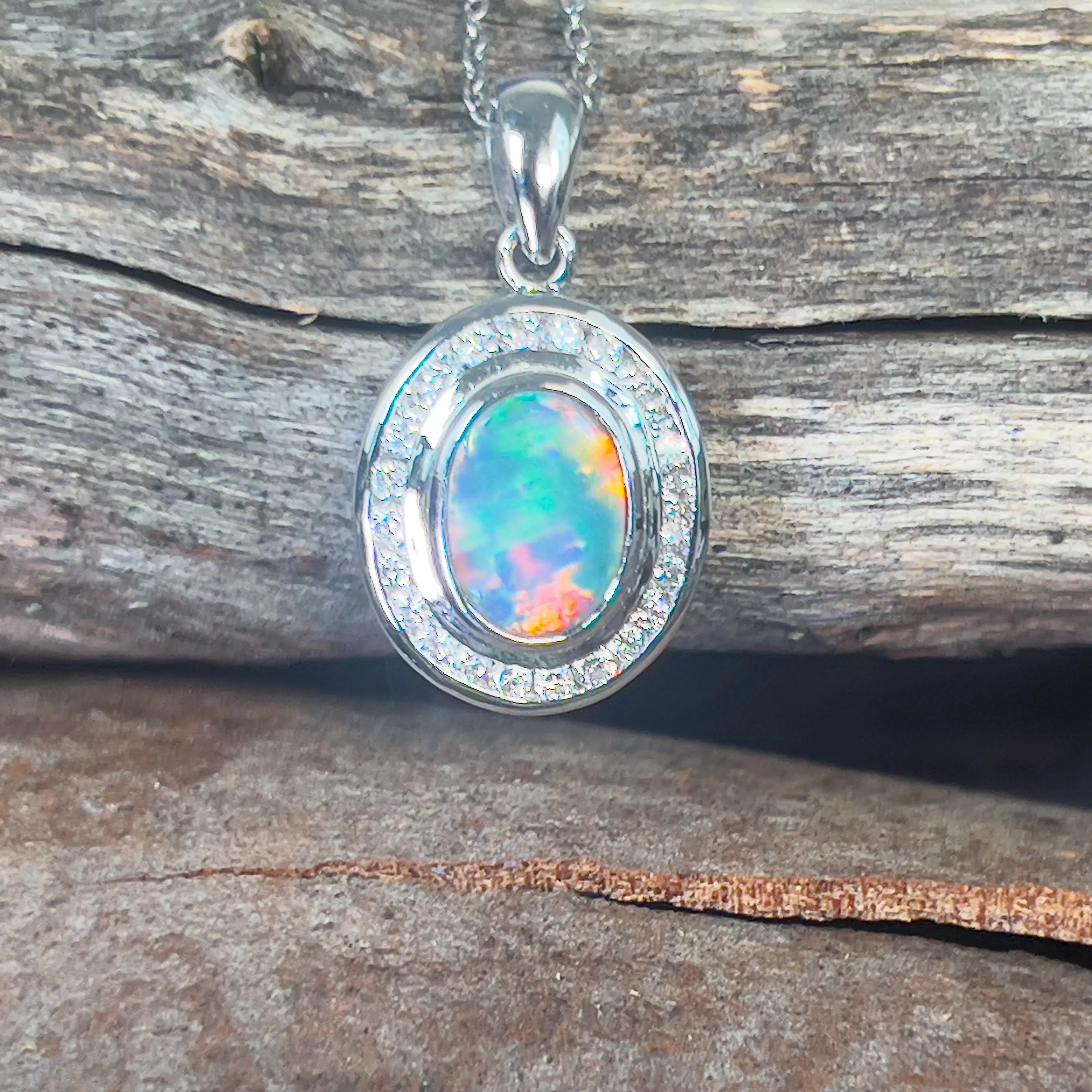 18kt White gold halo Black Opal 1.92ct Red flash pendant with diamonds pendant