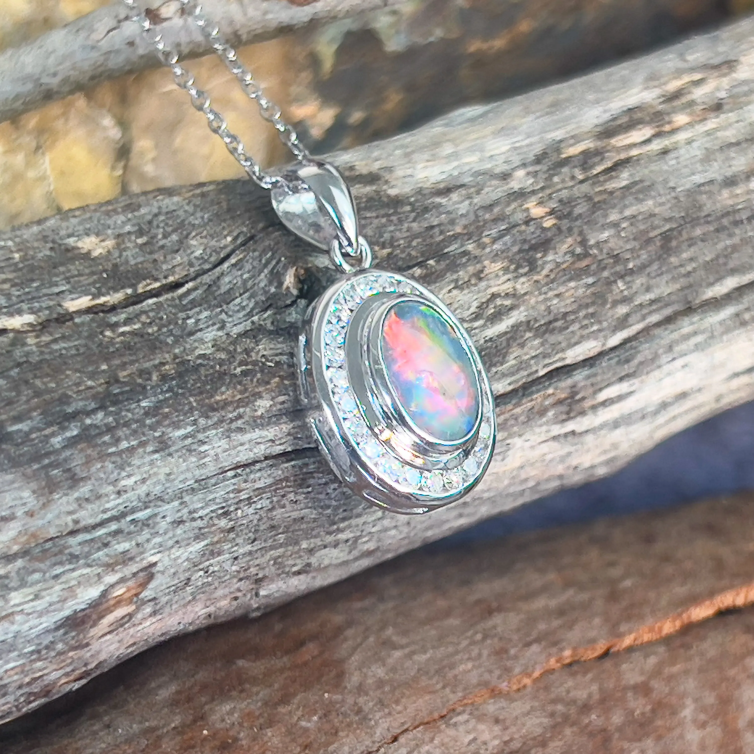 18kt White gold halo Black Opal 1.92ct Red flash pendant with diamonds pendant