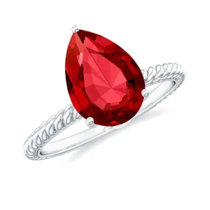 Pear Cut Created Ruby Solitaire Ring with Hidden Moissanite